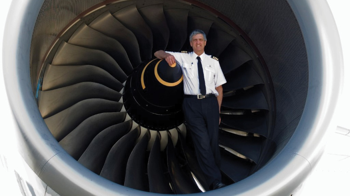 Pilot Richard Champion de Crespigny standing in airplane engine