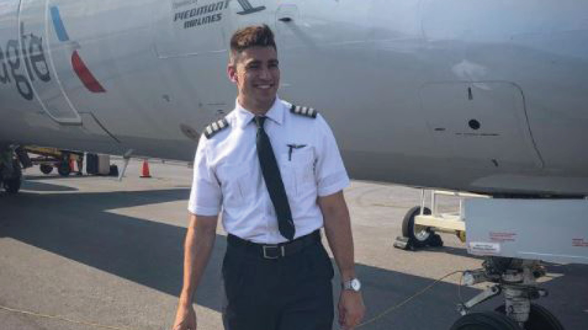 Pilot Drew standing outside aircraft.